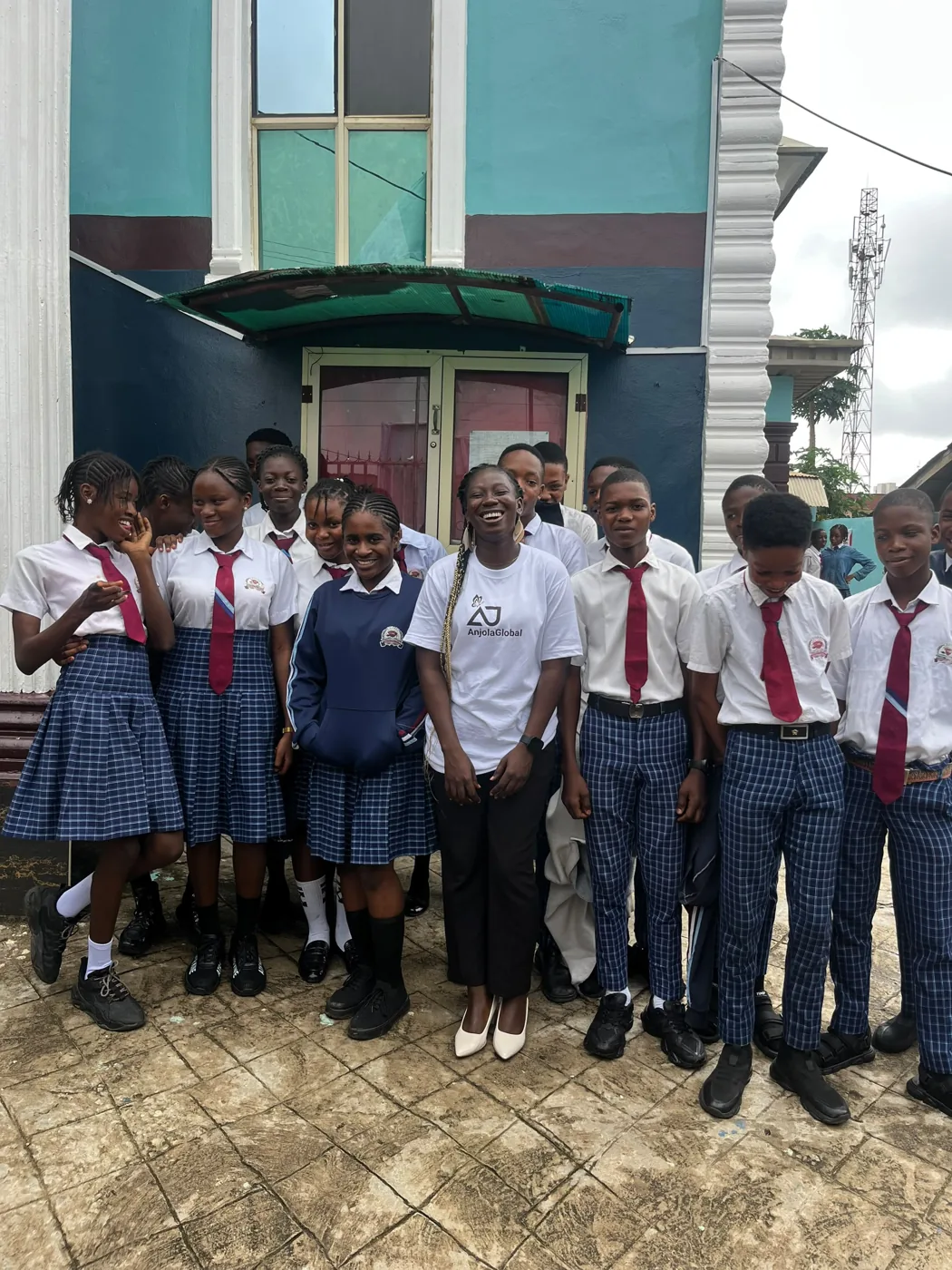 Anjola laughing with a group of students