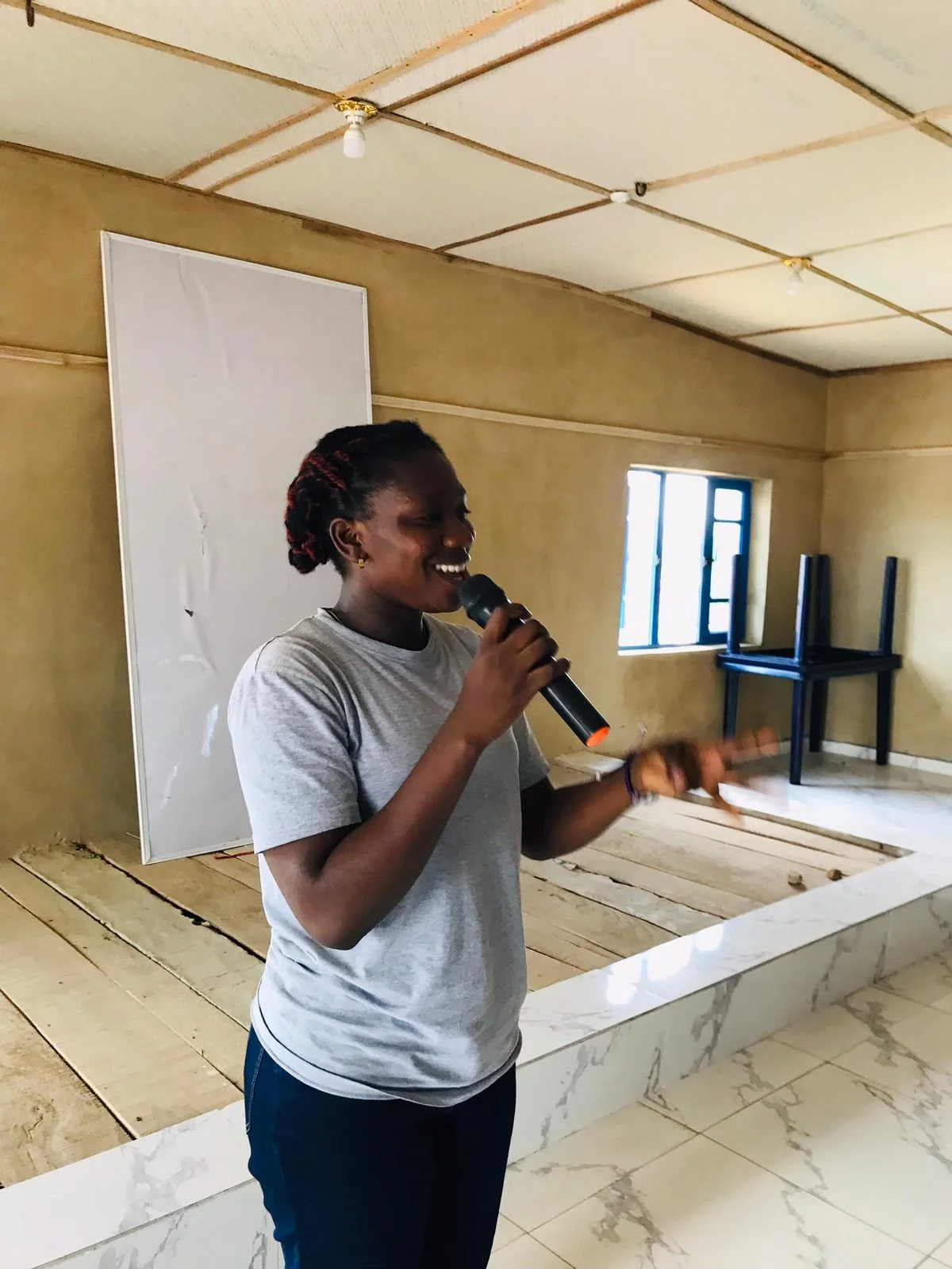 Anjola speaking with a microphone